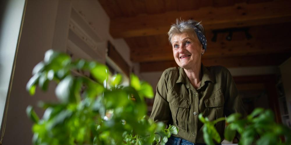 senior woman with potted plants
