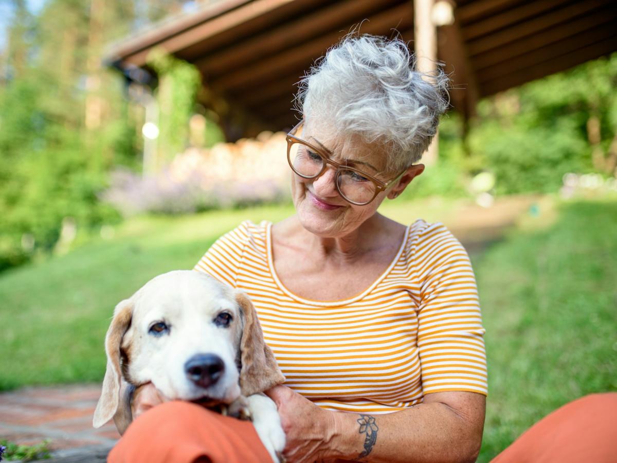 Senior woman with dog outdoors